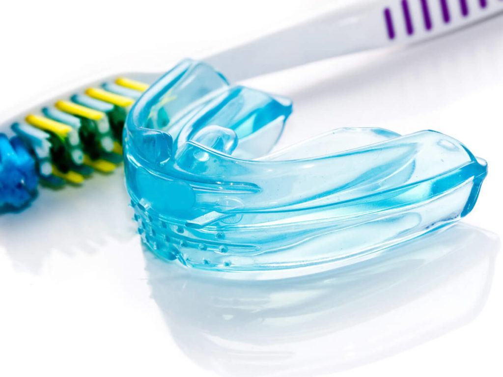 Blue mouthguard and toothbrush