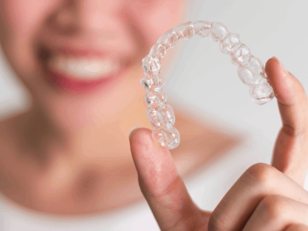 Woman holding a clear retainer