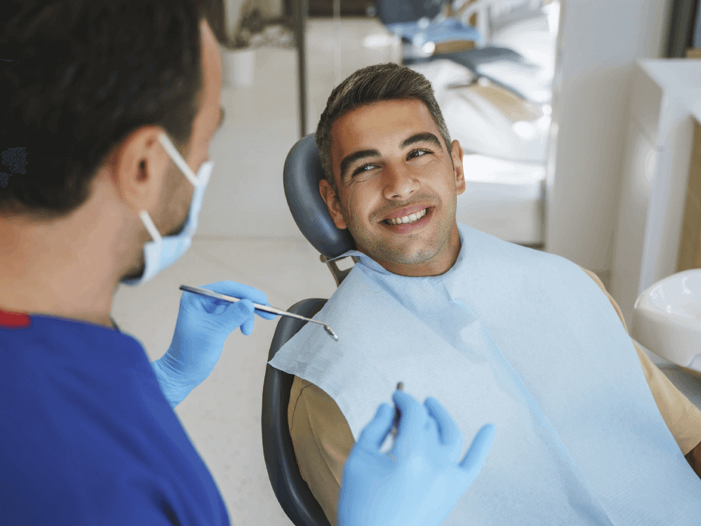 Patient smiling up at his dentist