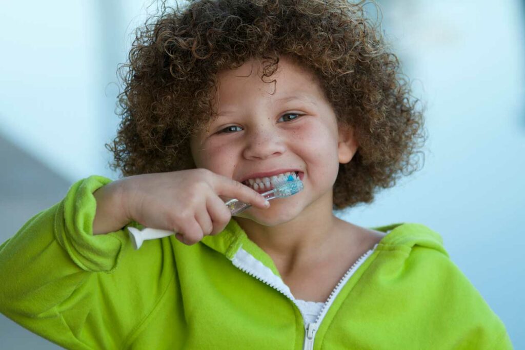 Photo of a child brushing his teeth